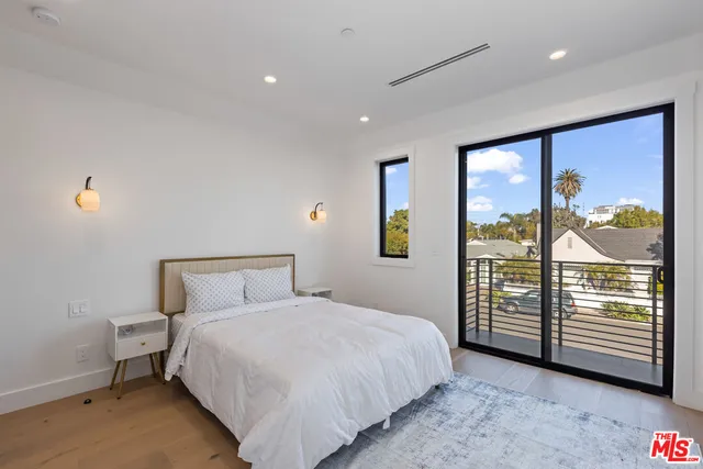 a bedroom with a large bed and a window