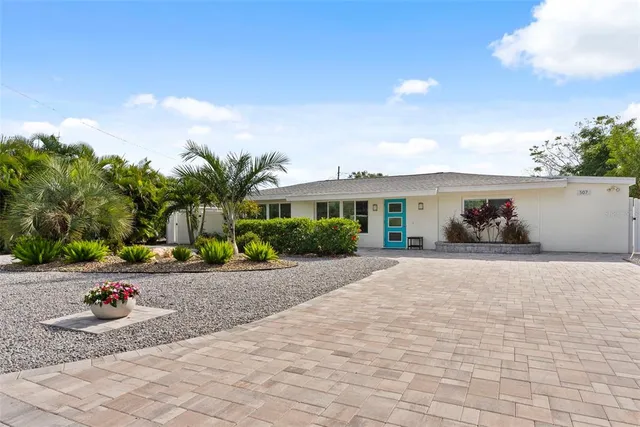 a front view of a house with a yard and a garage