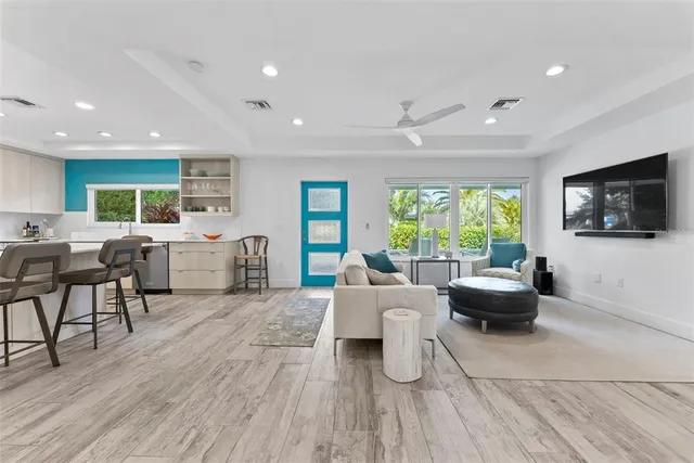 a kitchen with a sink and a stove top oven with wooden floor