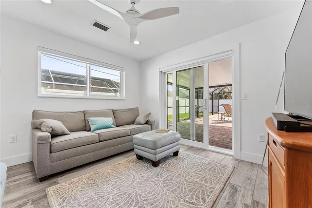 a living room with furniture and a floor to ceiling window