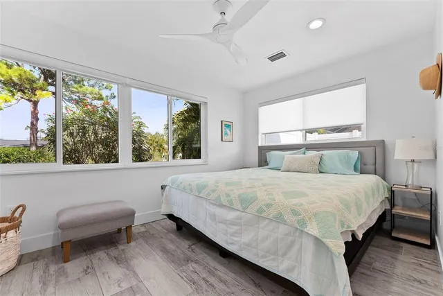 an aerial view of a city with lots of residential buildings and ocean view in back