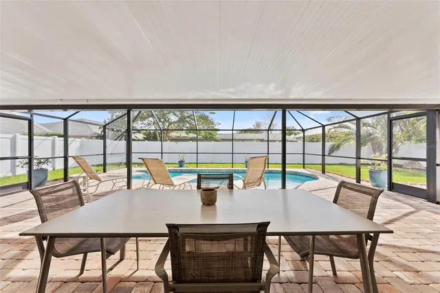 a swimming pool with outdoor seating and a garden