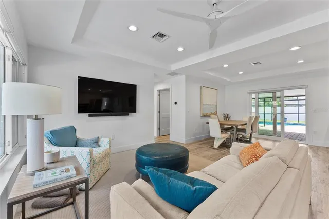 a kitchen with stainless steel appliances kitchen island granite countertop a table chairs sink and cabinets