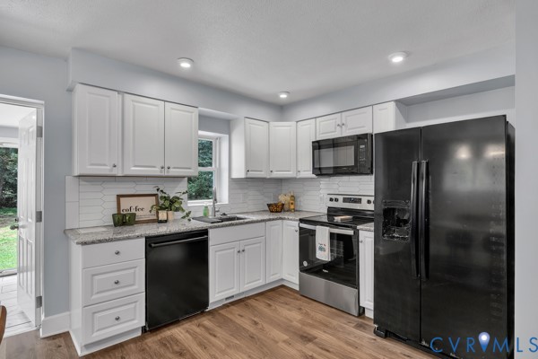 2330 Hubert Lane Chester, VA 23836 - Photo 12 of 43 Kitchen with black appliances, backsplash, light w