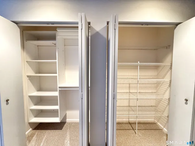 a view of walk in closet with empty racks