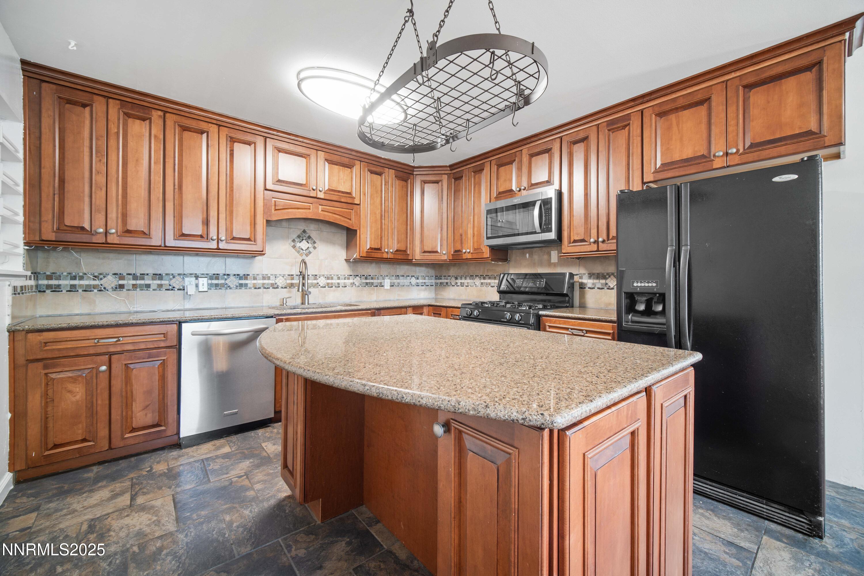 1895 Citron Street Reno, NV 89512 - Photo 12 of 37 a kitchen with stainless steel appliances granite countertop a sink stove refrigerator and cabinets