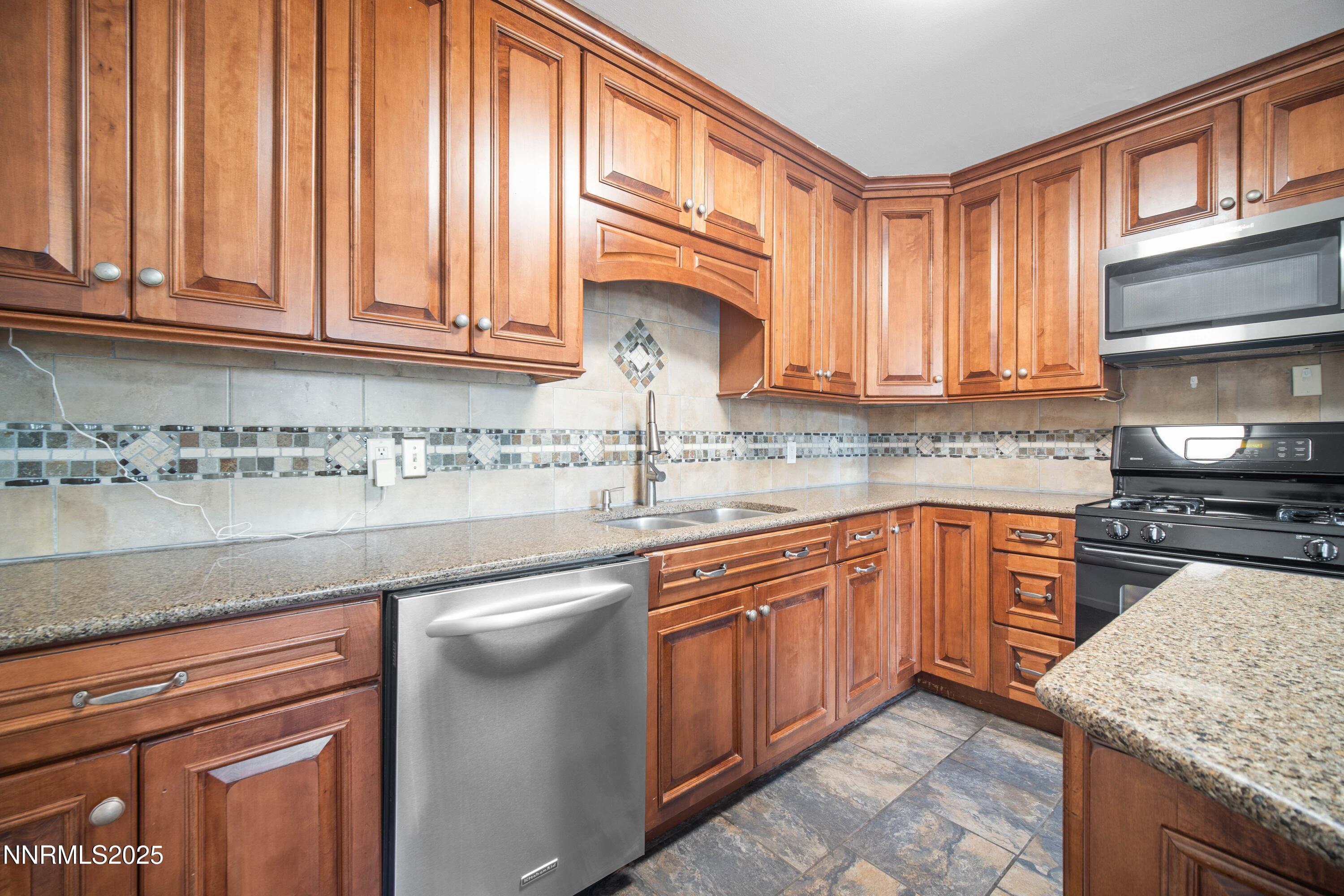 1895 Citron Street Reno, NV 89512 - Photo 13 of 37 a kitchen with stainless steel appliances granite countertop a sink dishwasher stove and cabinets with wooden floor