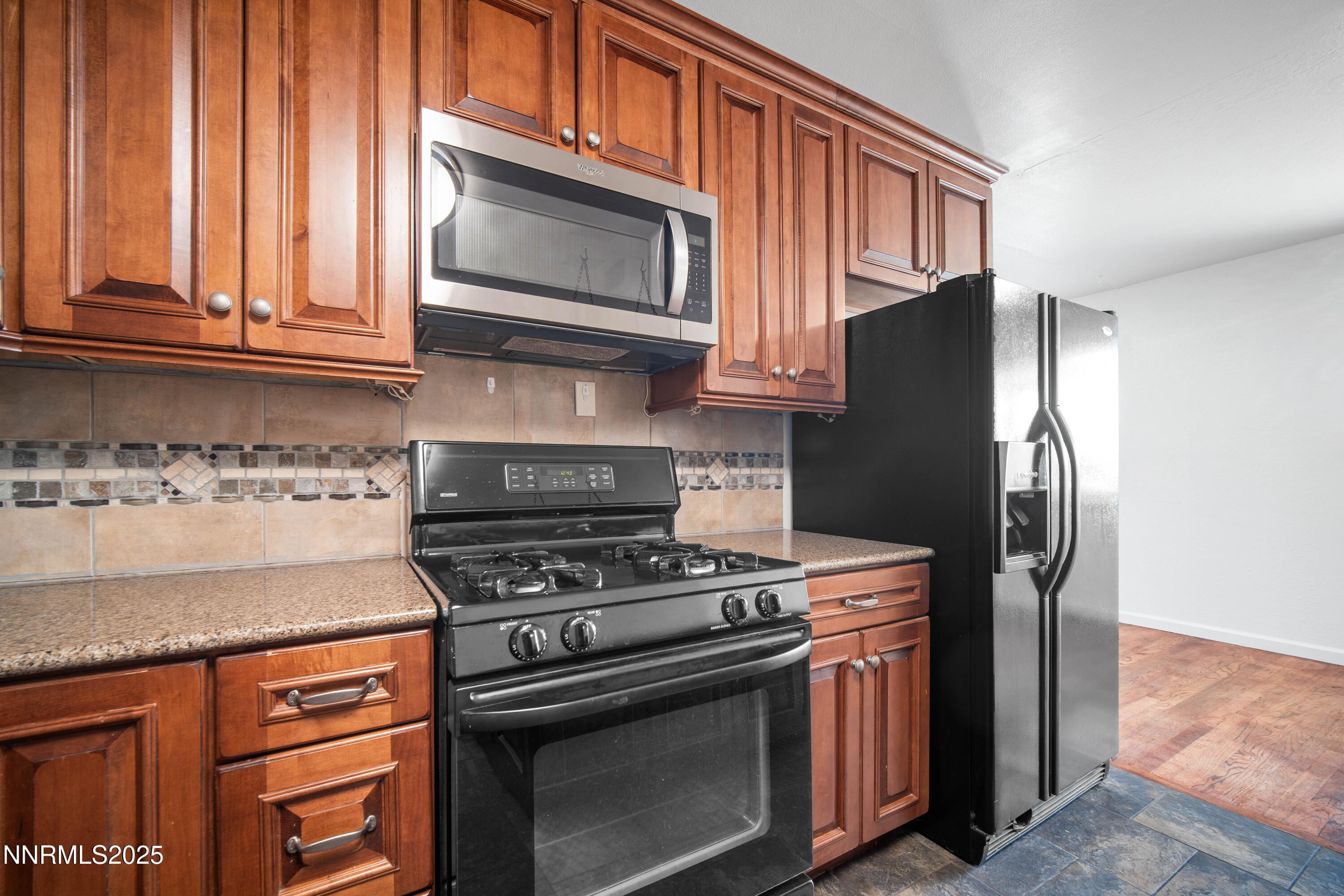 1895 Citron Street Reno, NV 89512 - Photo 14 of 37 a kitchen with stainless steel appliances granite countertop a stove microwave and refrigerator
