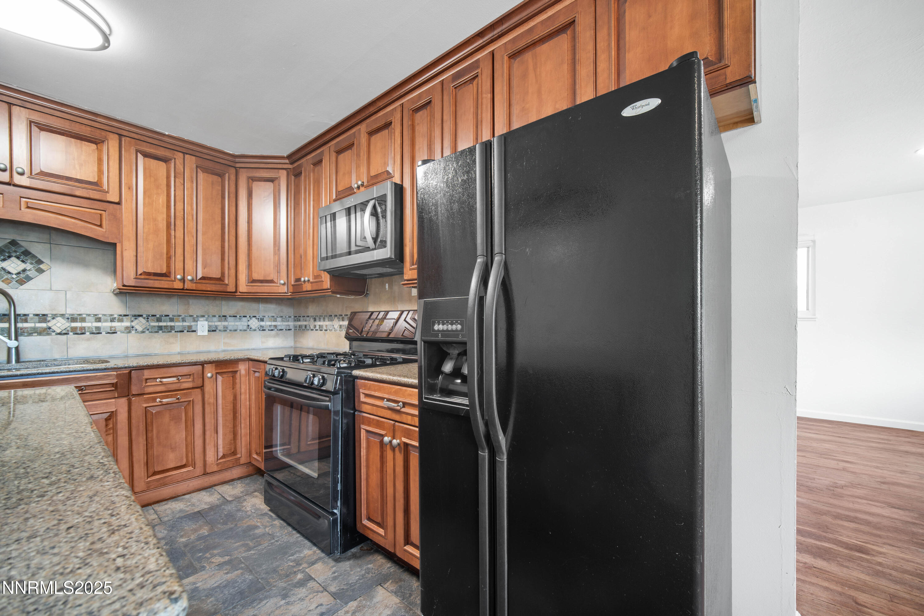 1895 Citron Street Reno, NV 89512 - Photo 15 of 37 a kitchen with stainless steel appliances granite countertop a refrigerator and a sink