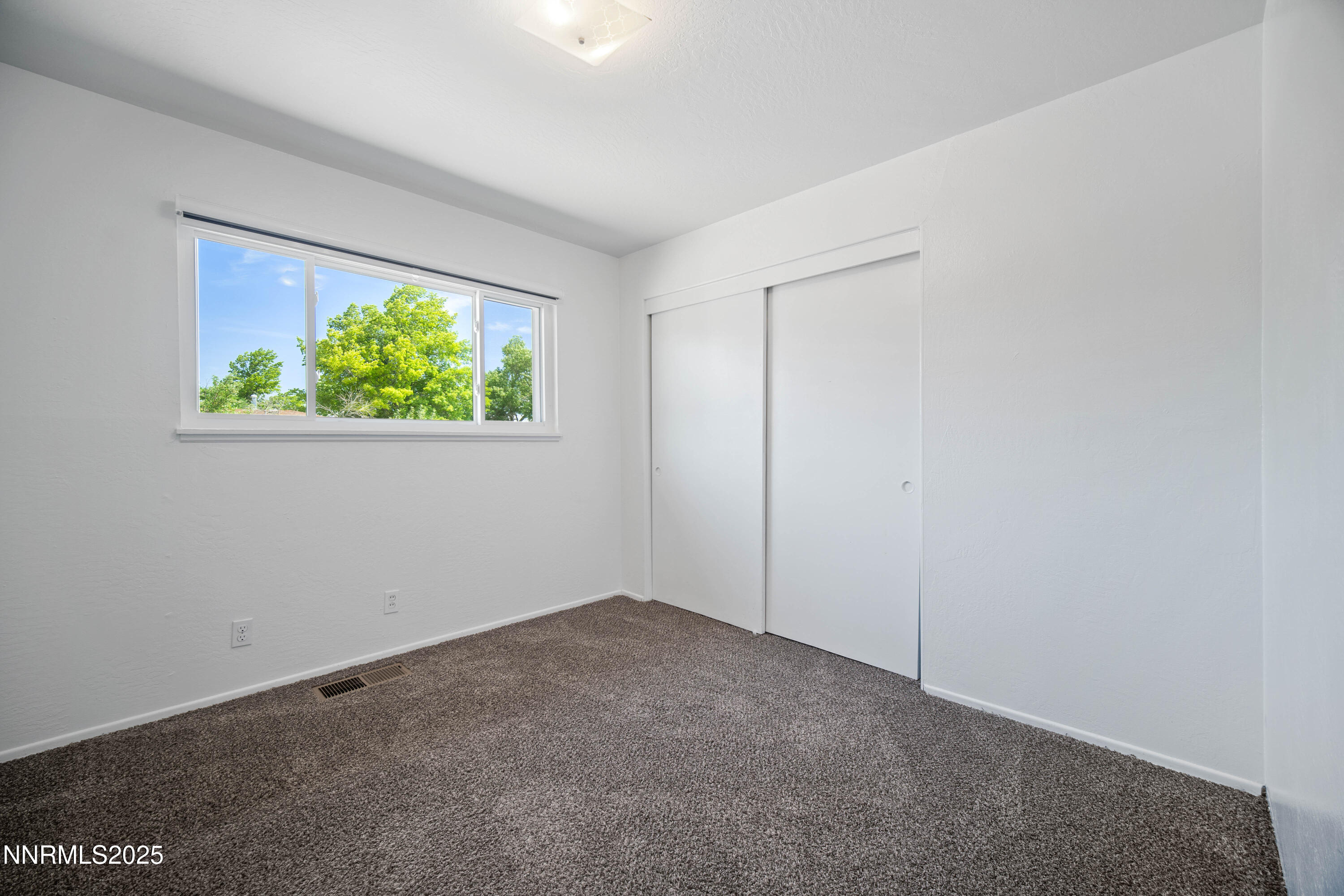1895 Citron Street Reno, NV 89512 - Photo 21 of 37 a view of an empty room with a window and a ceiling fan