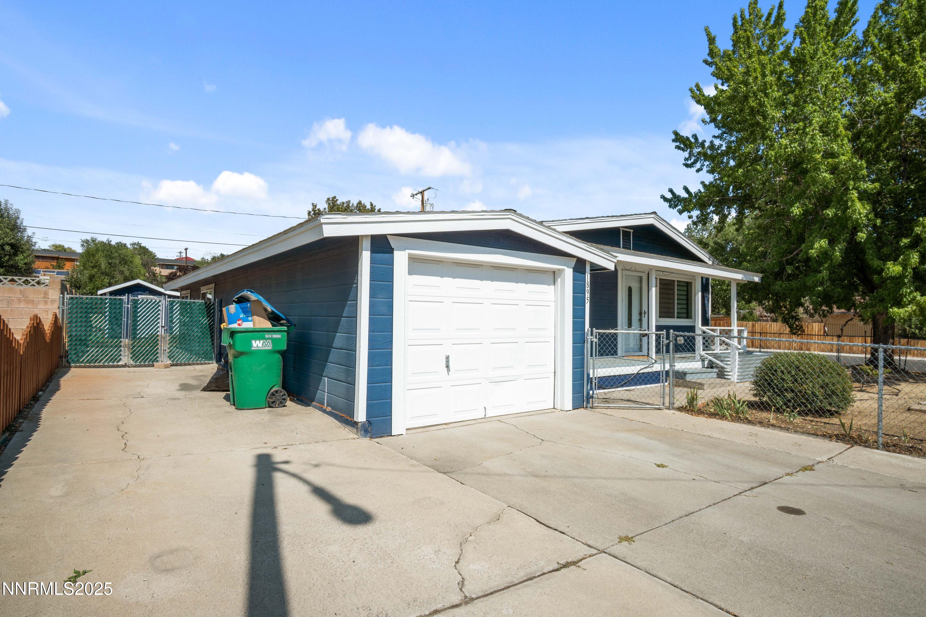 1895 Citron Street Reno, NV 89512 - Photo 3 of 37 a front view of a house with a yard and garage