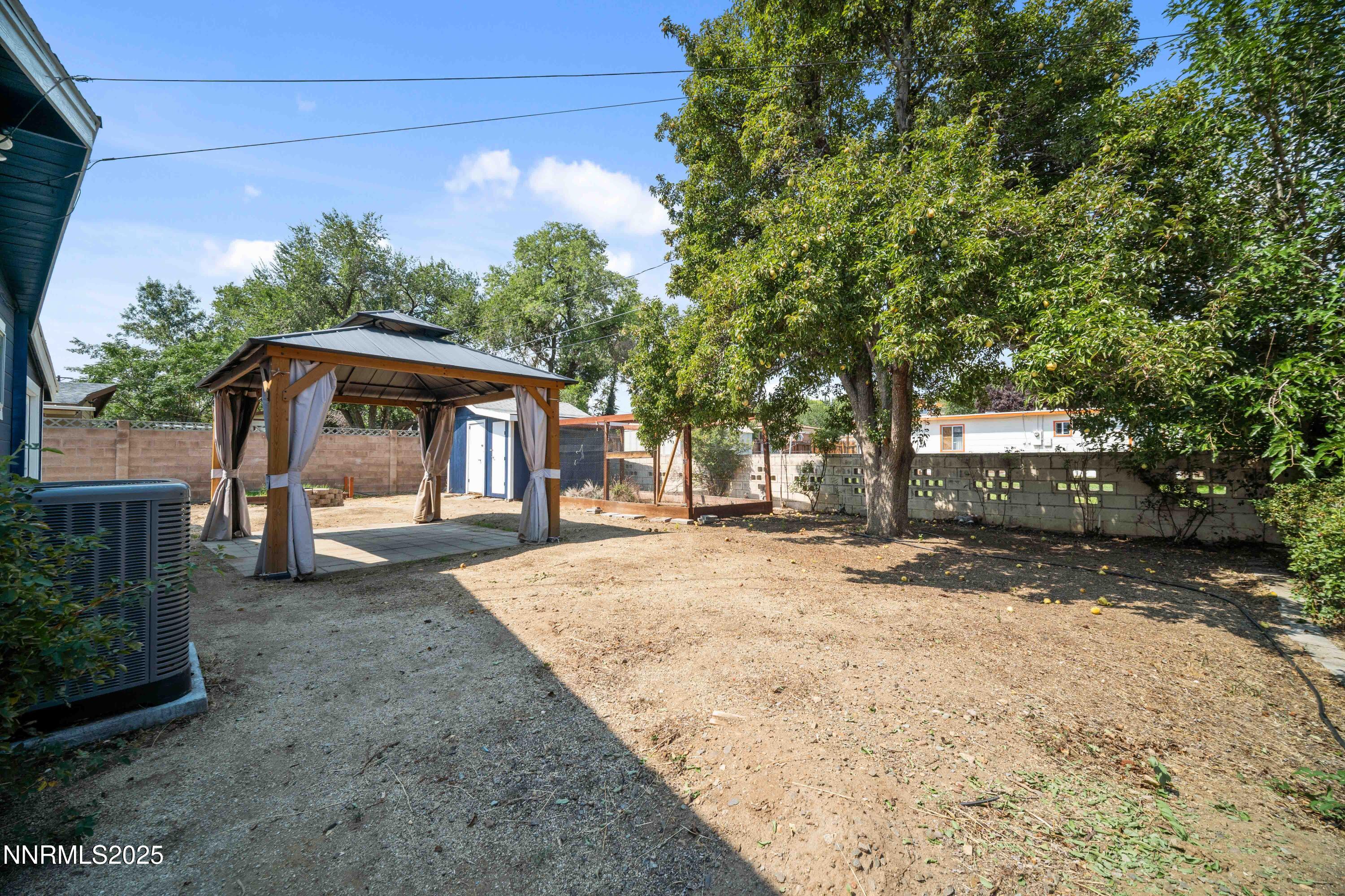 1895 Citron Street Reno, NV 89512 - Photo 32 of 37 a patio with a table and chairs and a large tree