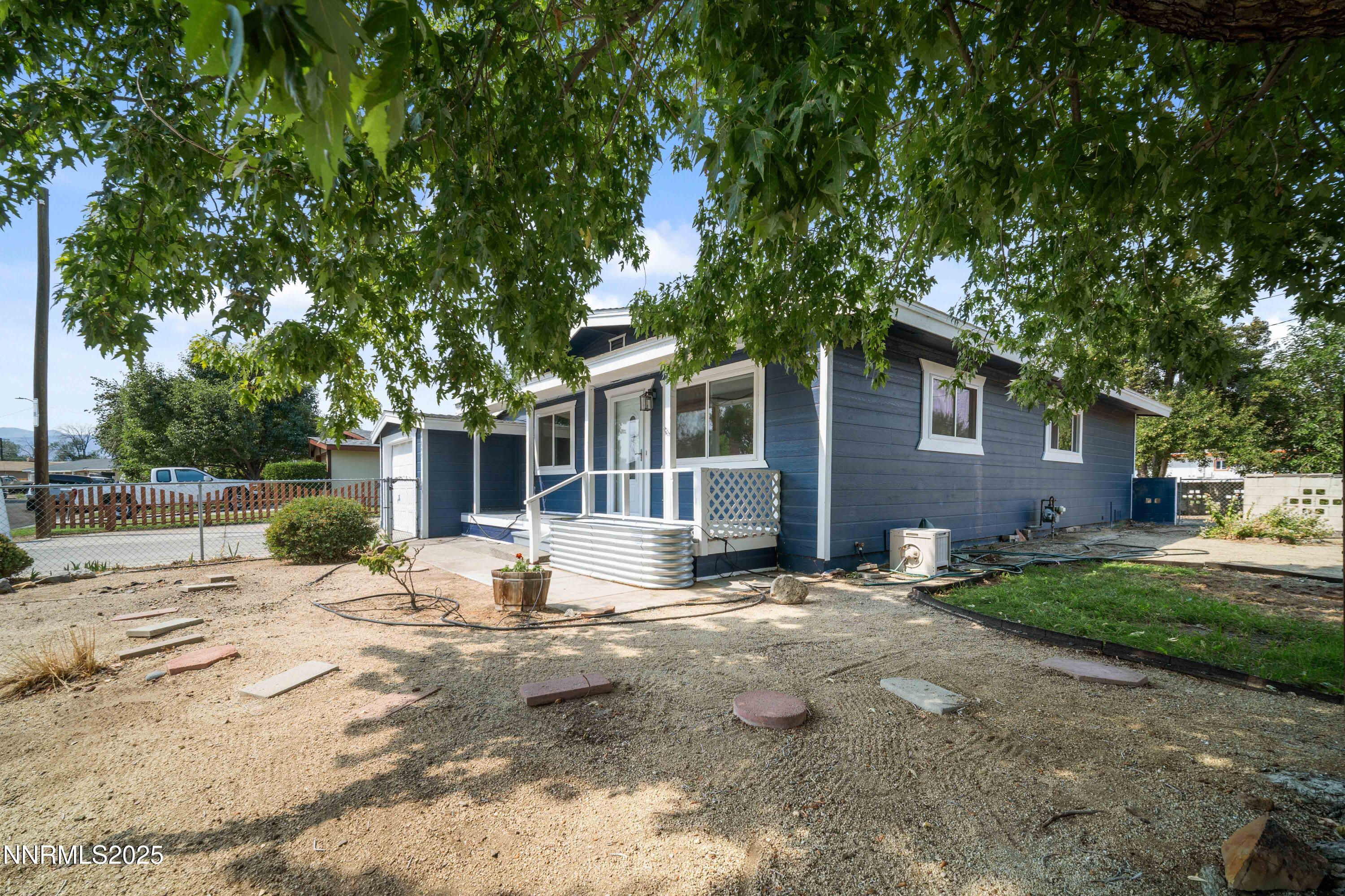 1895 Citron Street Reno, NV 89512 - Photo 6 of 37 a view of a backyard with table and chairs and a large tree