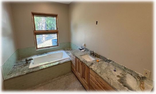 10505 Crosby Lynchburg Road Highlands, TX 77562 - Photo 19 of 24 a bathroom with a tub sink and mirror
