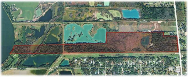 a view of a house with a yard and a pond