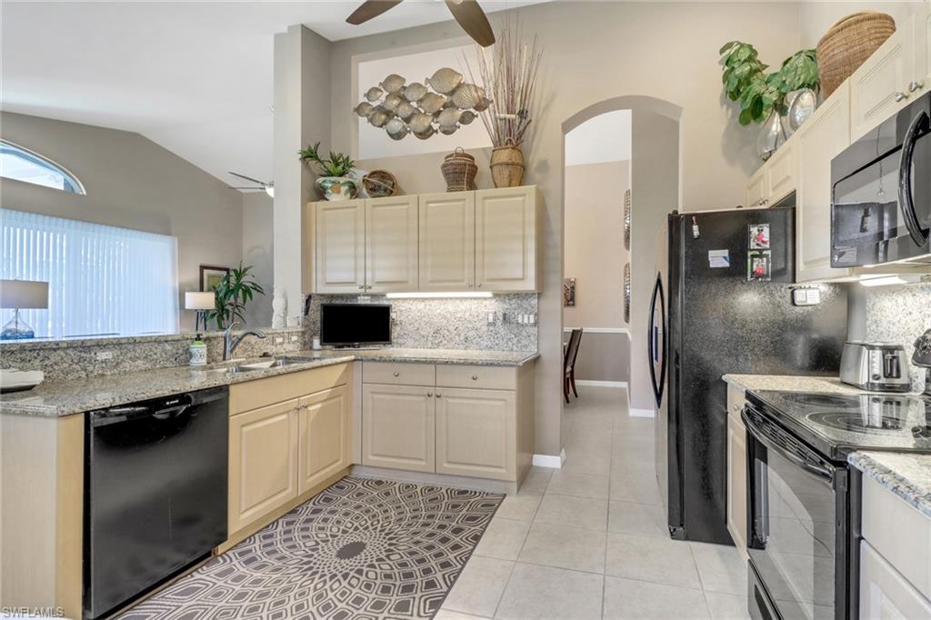 9001 Springview Loop Estero, FL 33928 - Photo 11 of 50 a kitchen with a sink stove and cabinets