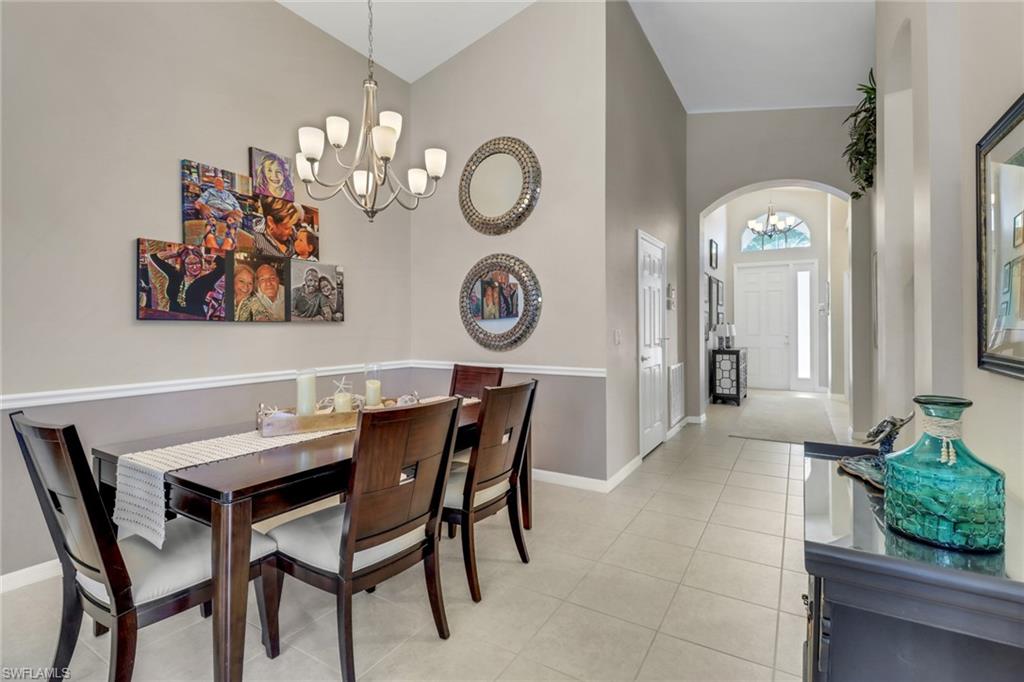 9001 Springview Loop Estero, FL 33928 - Photo 14 of 50 a view of a dining room with furniture and a chandelier