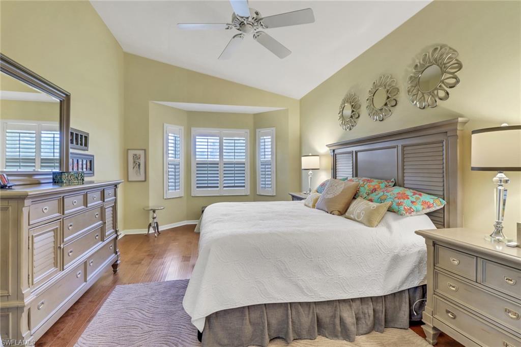 9001 Springview Loop Estero, FL 33928 - Photo 15 of 50 a living room with a bed and a dresser with mirror