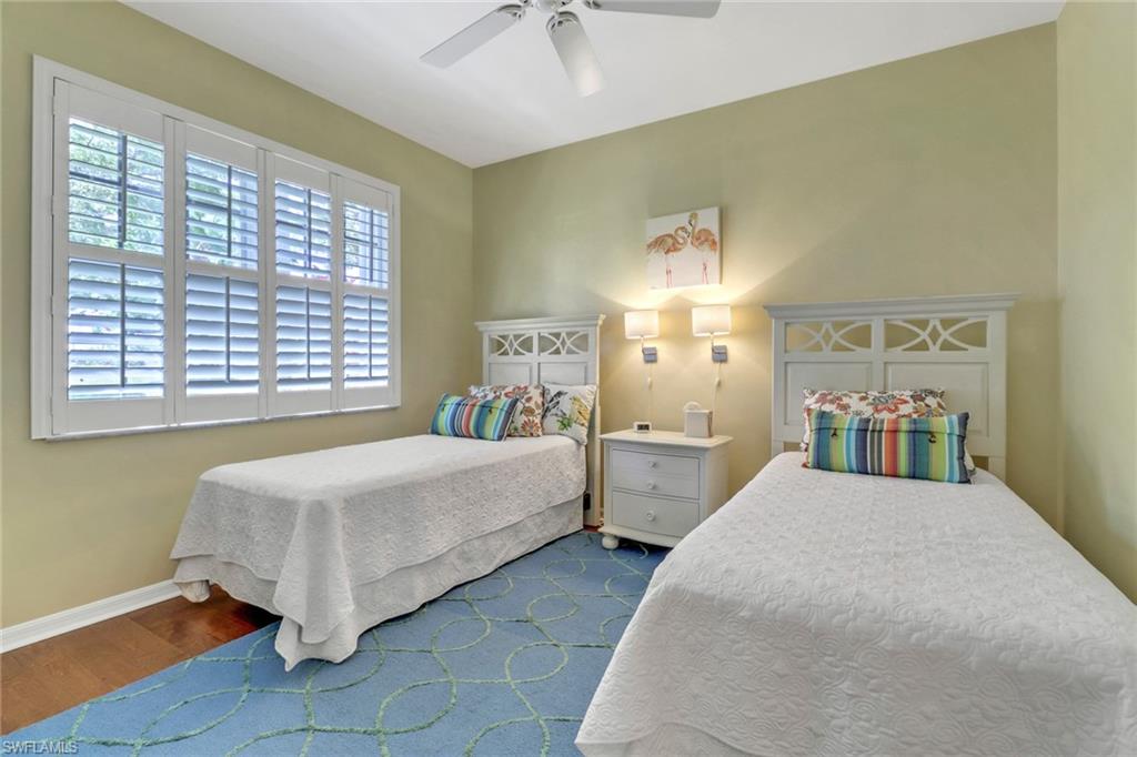9001 Springview Loop Estero, FL 33928 - Photo 21 of 50 a spacious bedroom with a bed and a chandelier