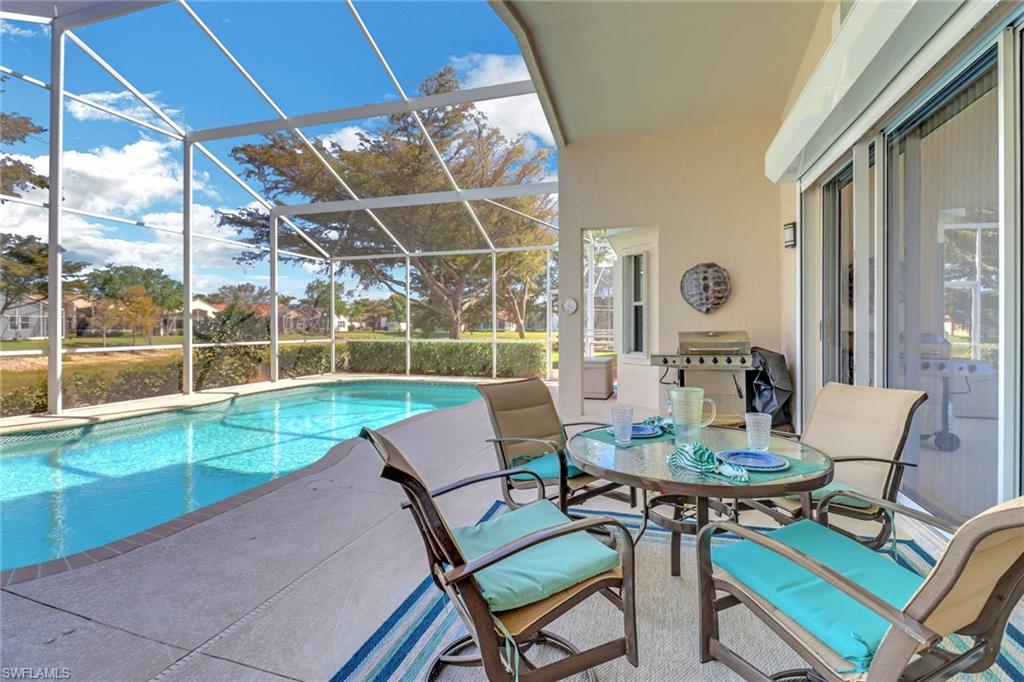 9001 Springview Loop Estero, FL 33928 - Photo 23 of 50 a view of a patio with a dining table and chairs