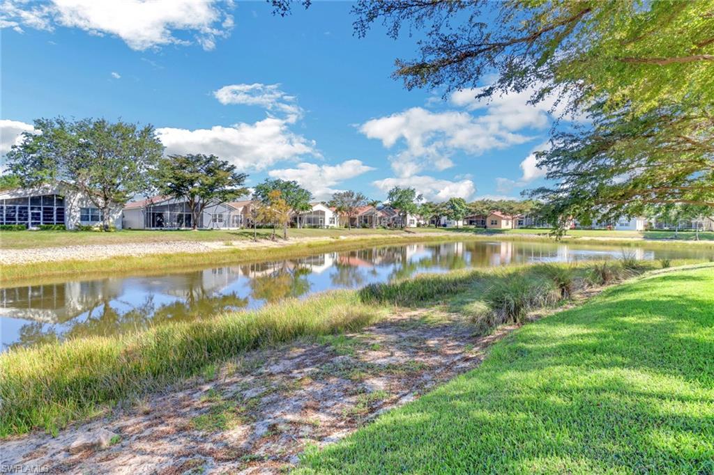 9001 Springview Loop Estero, FL 33928 - Photo 27 of 50 a view of a lake with houses in the back