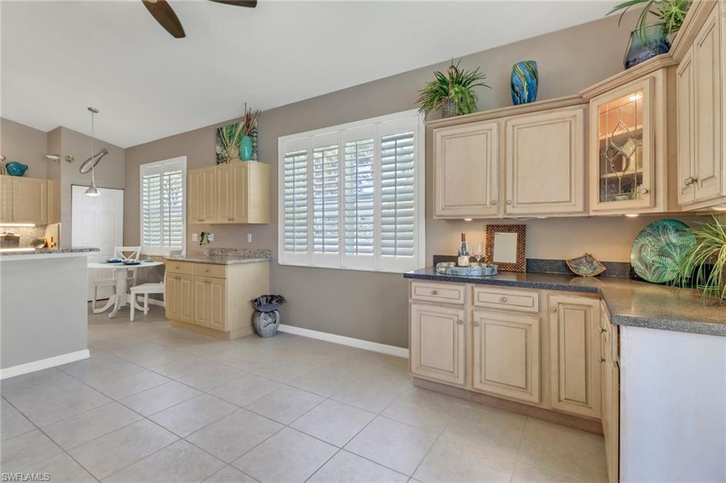 9001 Springview Loop Estero, FL 33928 - Photo 7 of 50 a kitchen that has a sink and a stove in it
