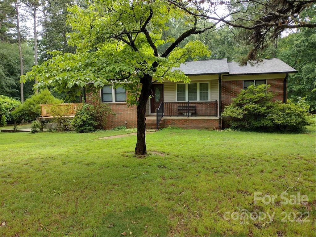 2413 Dan Reel Road Denver, NC 28037 - Photo 1 of 26 a front view of a house with garden