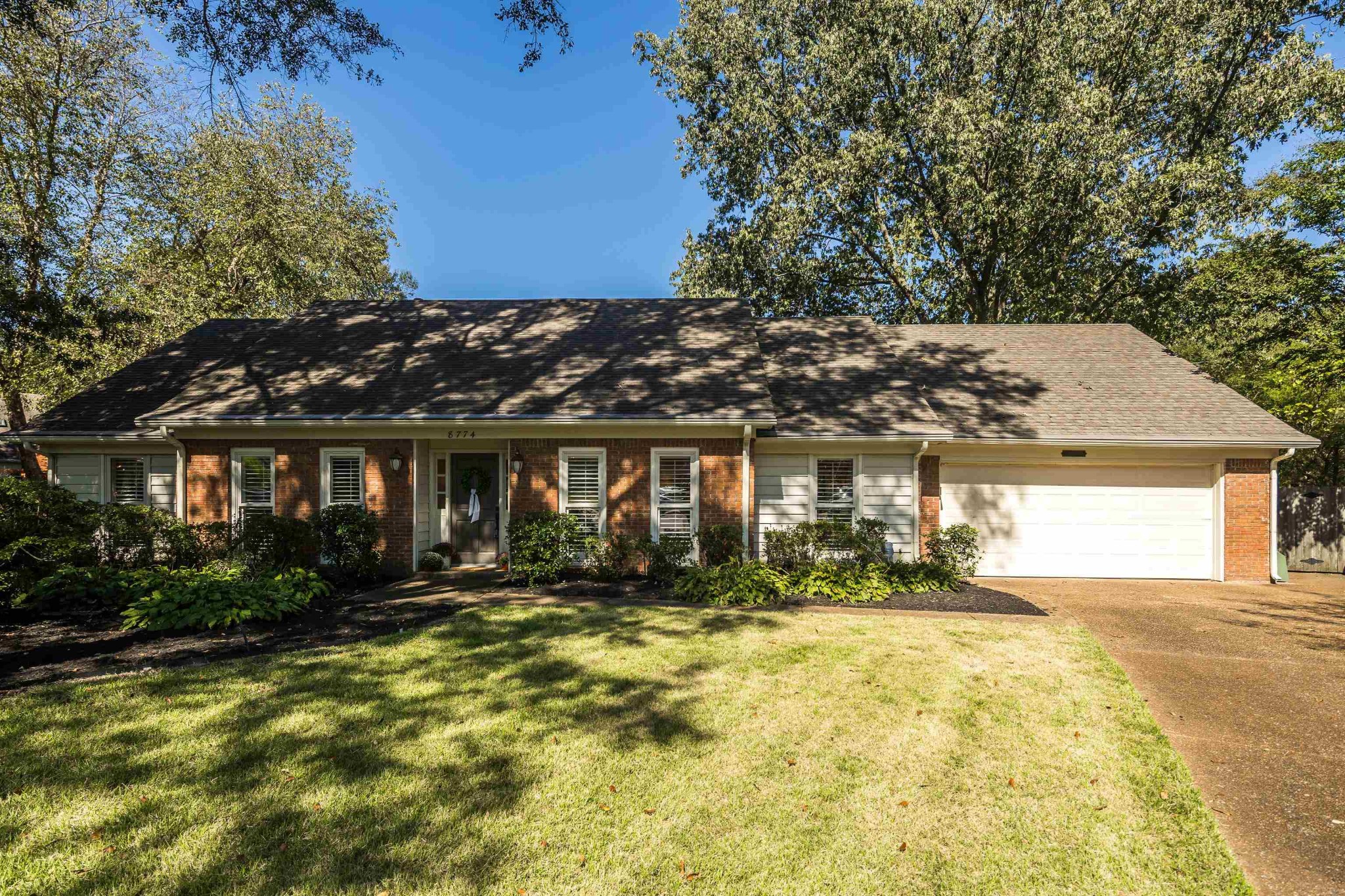 8774 Yorkchester Road Memphis, TN 38139 - Photo 1 of 23 a front view of house with yard and trees around