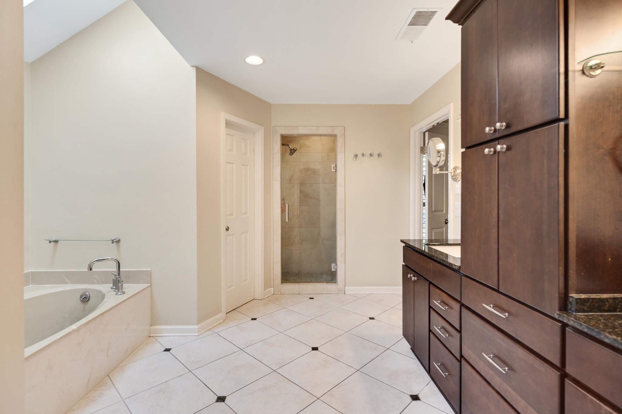 8774 Yorkchester Road Memphis, TN 38139 - Photo 16 of 23 a spacious bathroom with a tub shower and mirror