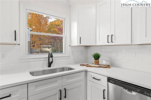 a kitchen with cabinets and window