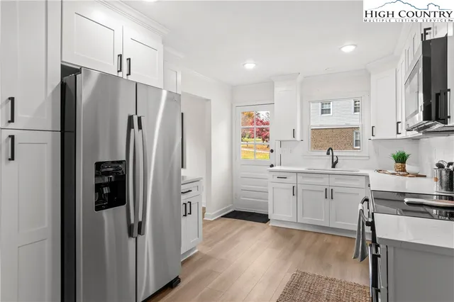 an empty room with window and ceiling fan