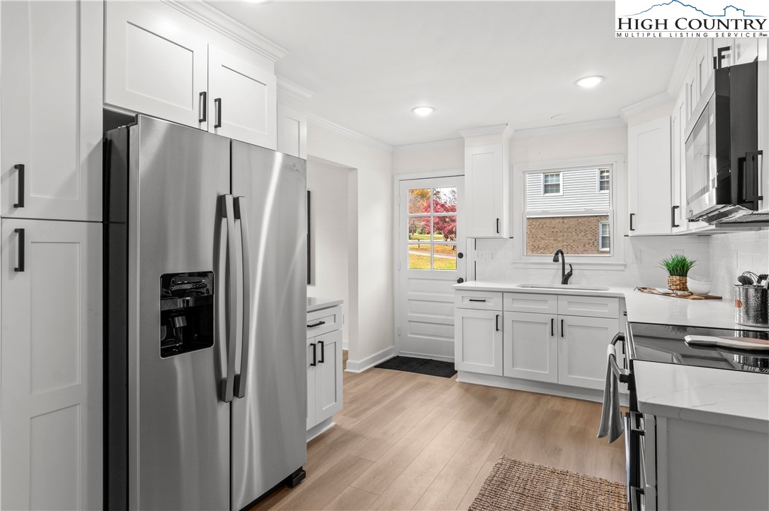 765 Laverton Lane Rural Hall, NC 27045 - Photo 19 of 41 a kitchen with stainless steel appliances a refrigerator sink and stove