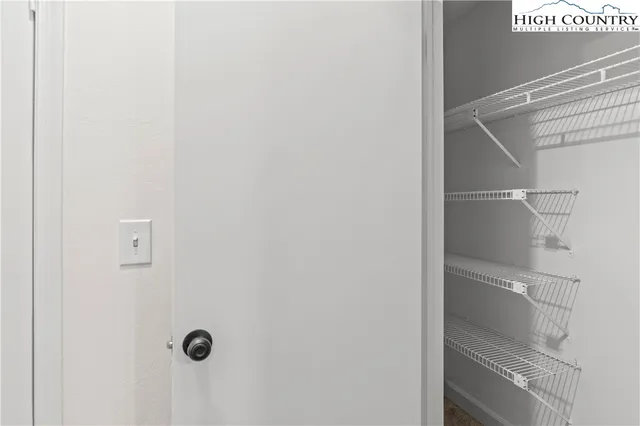 an empty room with a window and a ceiling fan