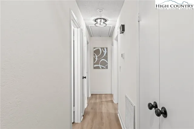 an empty room with window and ceiling fan