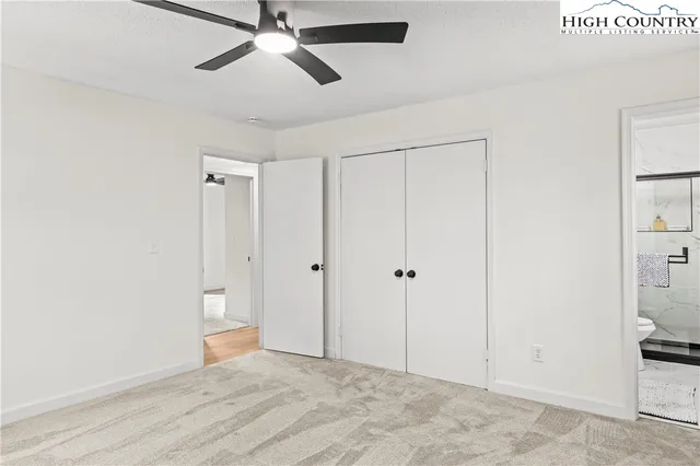 a front view of a house with a garden and trees