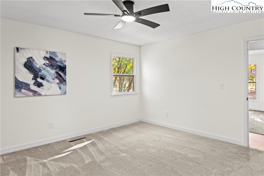 765 Laverton Lane Rural Hall, NC 27045 - Photo 26 of 41 an empty room with windows and fan