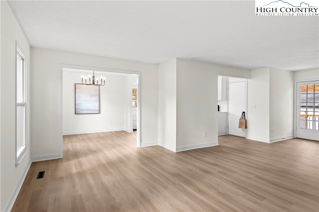 765 Laverton Lane Rural Hall, NC 27045 - Photo 6 of 41 an empty room with wooden floor and windows