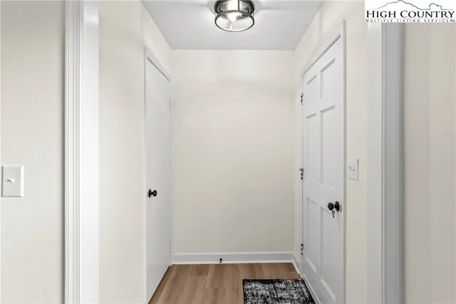 a view of a kitchen with wooden floor and electronic appliances