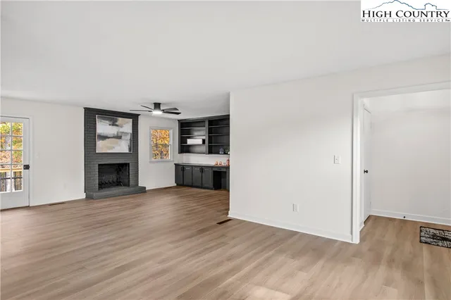 a kitchen with stainless steel appliances a large counter top and a fireplace