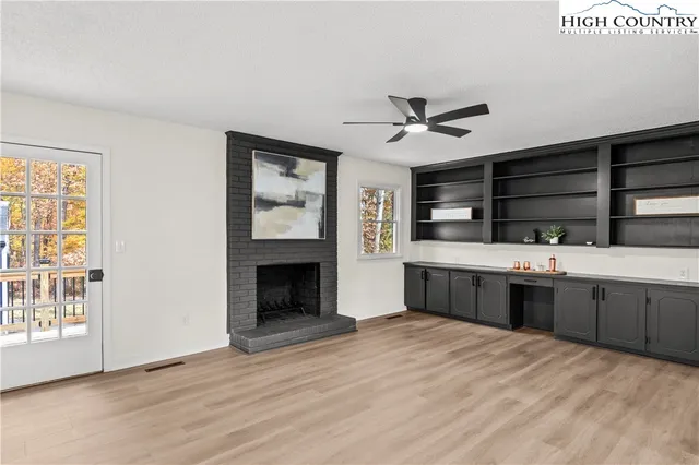 a view of a livingroom with a hardwood floor and a ceiling fan