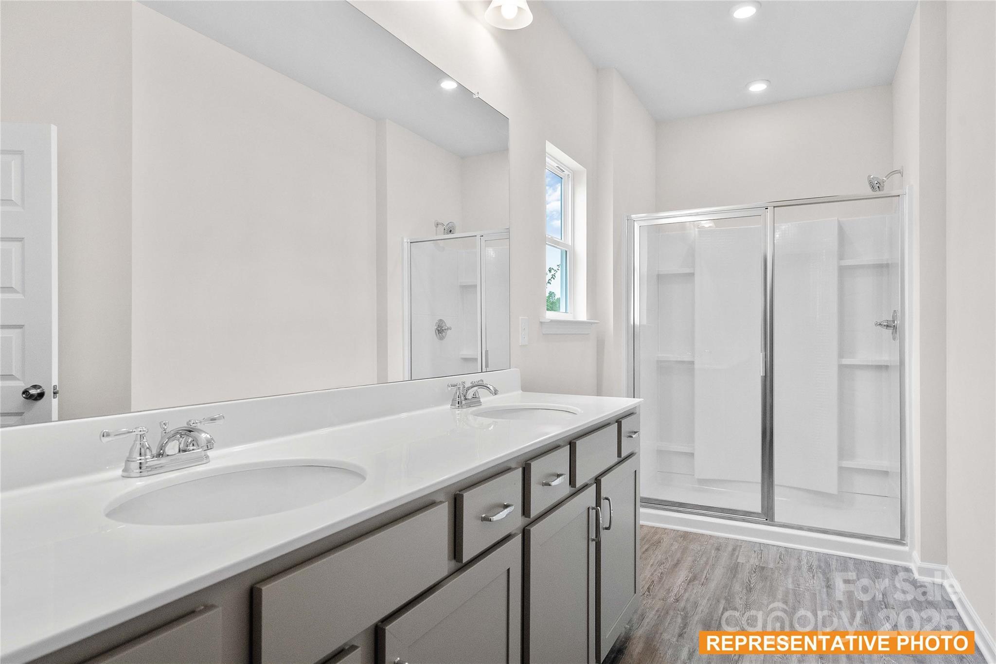 6013 Jasmine Br Road Charlotte, NC 28216 - Photo 13 of 26 a bathroom with a sink and a mirror