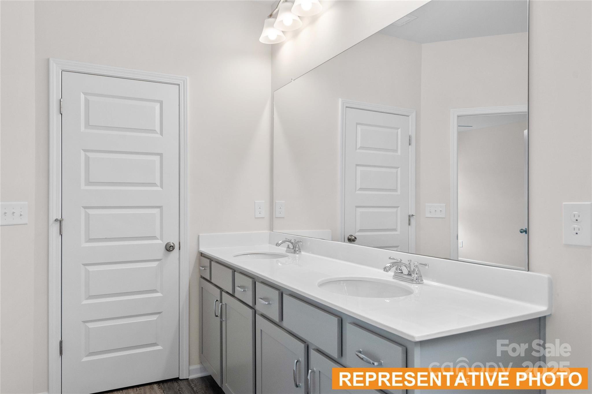 6013 Jasmine Br Road Charlotte, NC 28216 - Photo 14 of 26 a bathroom with a sink a vanity and a mirror