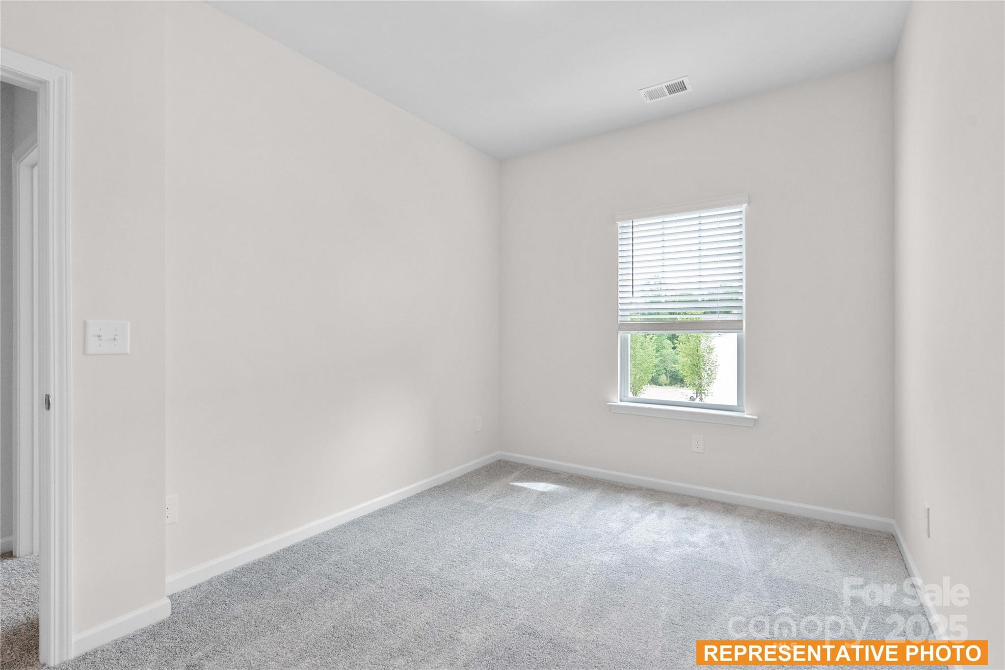 6013 Jasmine Br Road Charlotte, NC 28216 - Photo 17 of 26 an empty room with a window