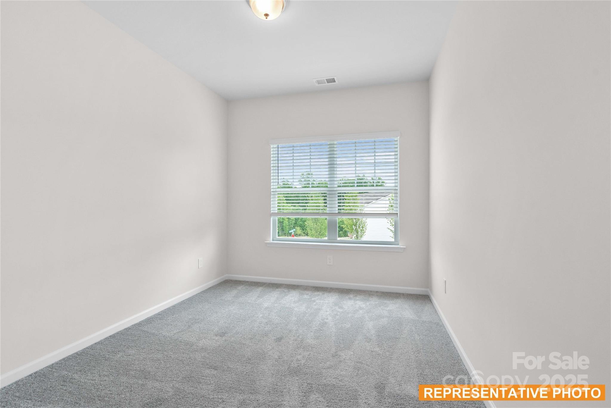 6013 Jasmine Br Road Charlotte, NC 28216 - Photo 19 of 26 an empty room with a window