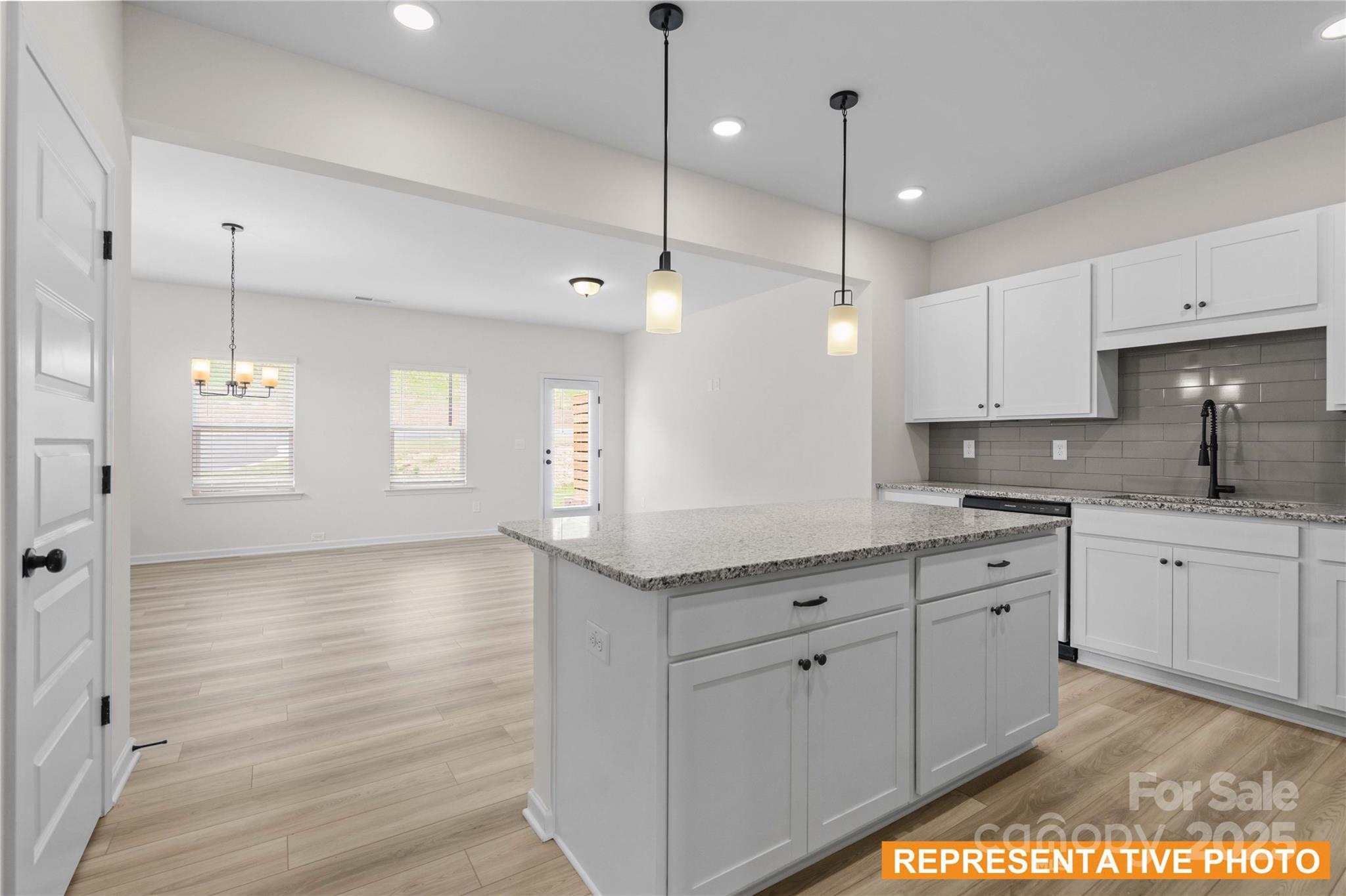 6013 Jasmine Br Road Charlotte, NC 28216 - Photo 5 of 26 a kitchen with white cabinets appliances and a window