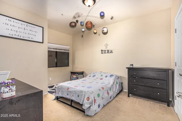 a bedroom with a bed and a dresser