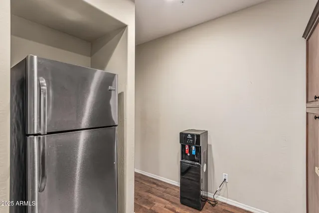 a view of a refrigerator in kitchen and wooden floor
