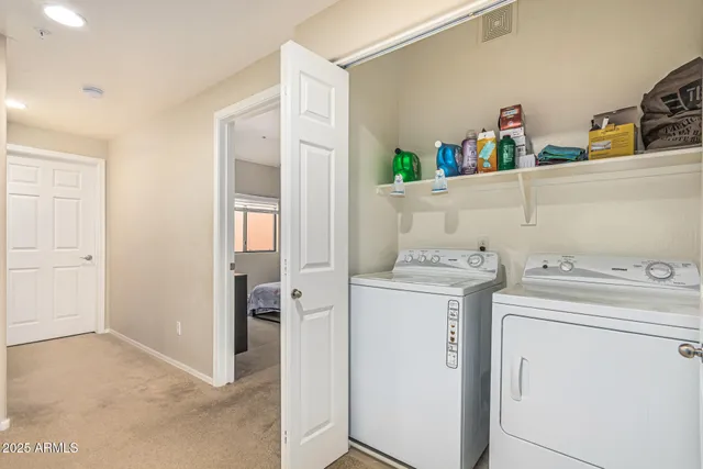 a view of storage and utility room with washer and dryer