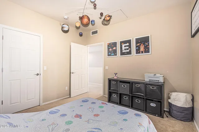 a bedroom with a bed and a dresser in it