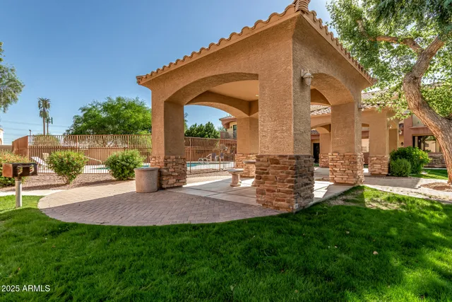 a view of a house with backyard and sitting area